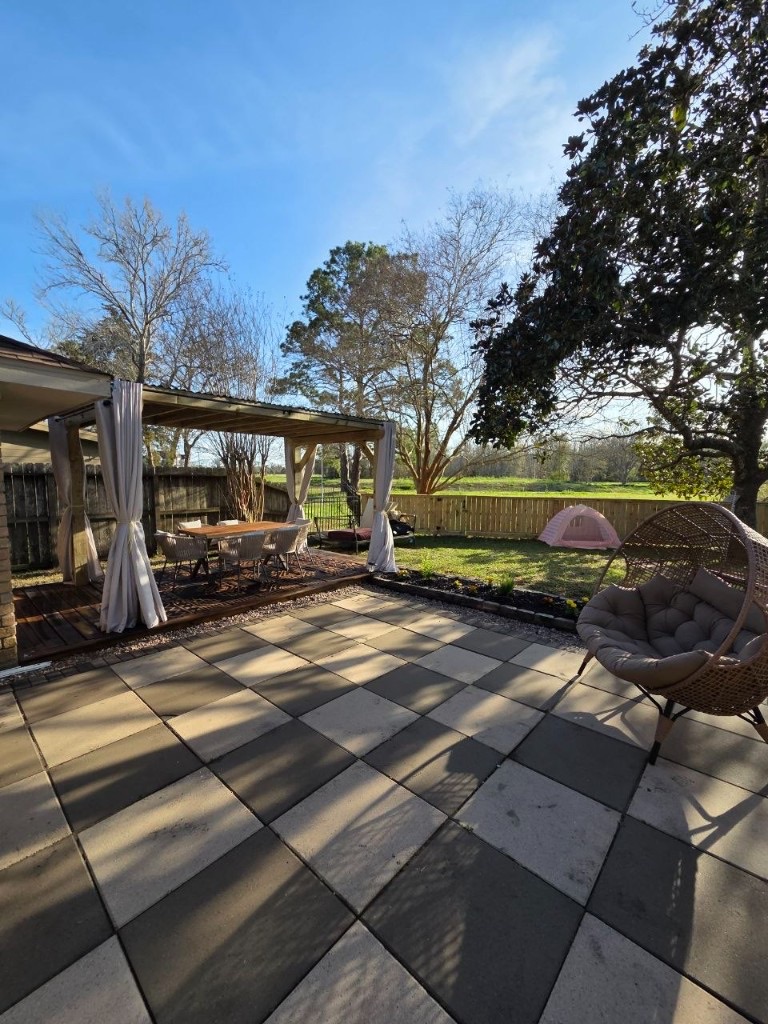 Finished checkerboard patio with pergola dining and outdoor living