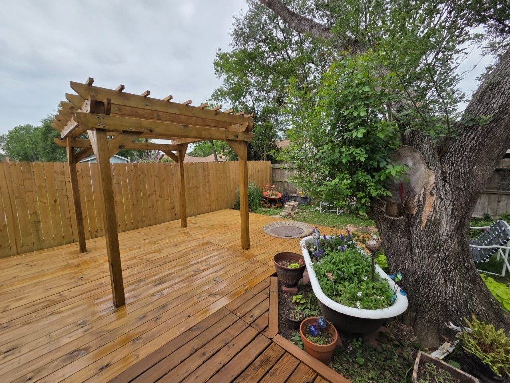 Finished wooden pergola and deck with outdoor dining